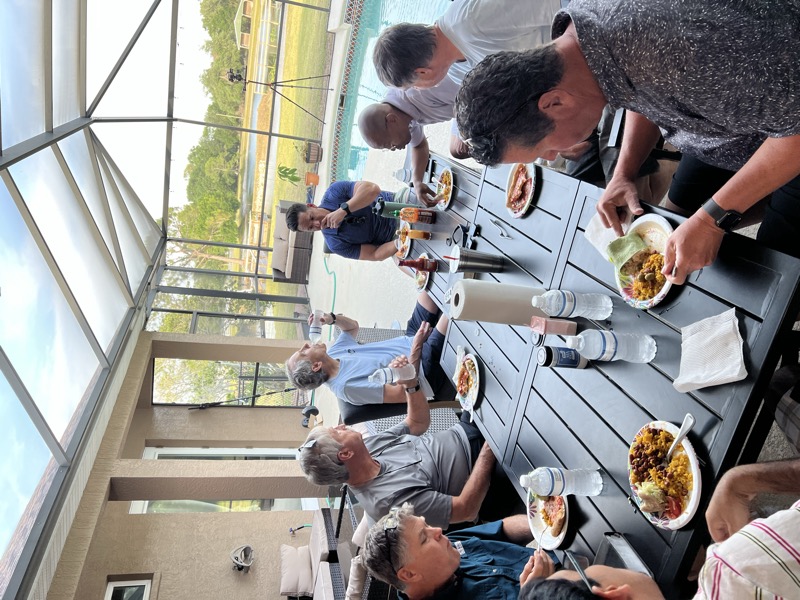 A men’s group sharing a meal together on the lanai at a Mission Hospitality property